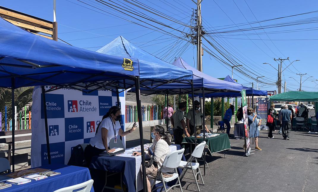 Funcionarios IPS atendiendo en stand.